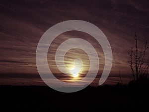 The midnight sun setting over the dark earth