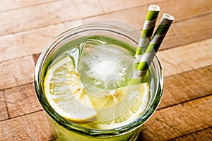 Midori Sour Cocktail with ice and lemon.