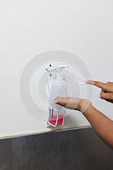 Midsection of biracial female doctor wearing scrubs washing hands in operating theatre, copy space