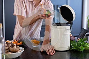 Midsection of biracial man cleaning waste in kitchen