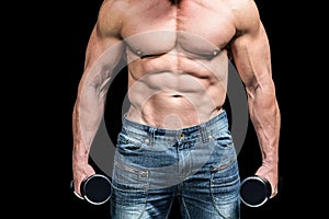 Midsection of bodybuilder with dumbbells