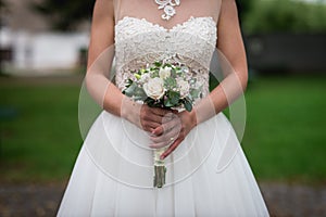 Midsection Of Bride Holding Bouquet