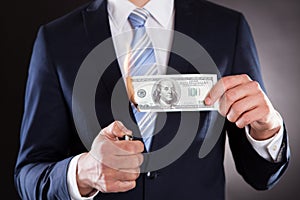 Midsection of businessman burning money photo