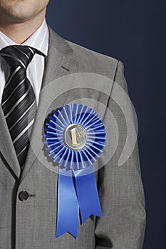 Midsection Of Businessman Wearing Blue Ribbon On Lapel