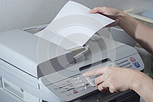 Midsection of businesswoman using fax machine