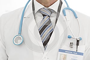 Midsection of doctor in labcoat with stethoscope at clinic