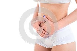 Midsection of female body suffering from stomach ache over white