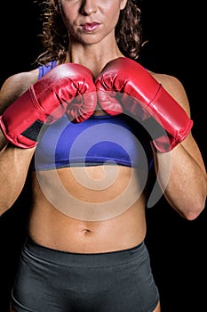Midsection of female boxer with fighting stance