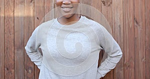 Midsection of happy african american woman in grey long sleeve sweatshirt, copy space, slow motion