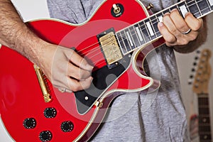 Midsection of man playing electric guitar