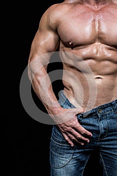 Midsection of man pulling denim
