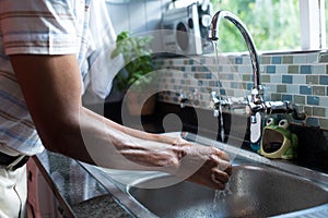 Midsection of man washing hands