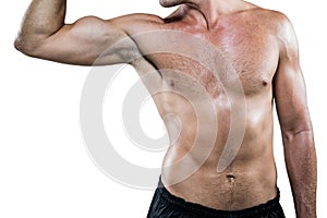 Midsection of shirtless athlete flexing muscles