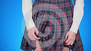 Midsection of teenage girl, cheat sheet written on hips hidden under a skirt. 4k, close-up, blue background, slow-motion