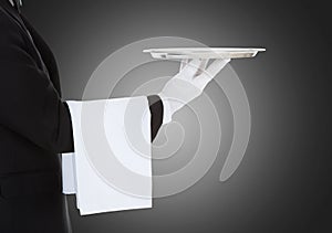 Waiter Holding Empty Silver Tray Over Gray Background