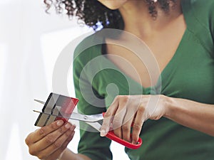 Midsection Of Woman Cutting Credit Card