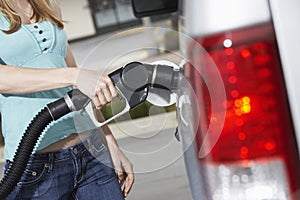 Midsection Of A Woman Refueling Her Car