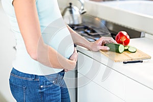 Midsection of woman with vegetables on board