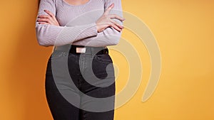 midsection of woman wearing tight black jeans