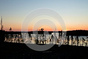 Midsummer night over lake Menstrask in Vasterbotten, Sweden