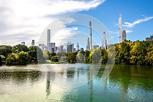 Midtown Manhattan skyscrapers with a view from The Lake at Central Park in NYC