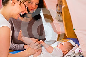 Midwife examining newborn baby