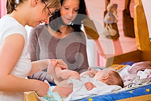 Midwife examining newborn baby