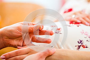 Midwife giving pregnancy acupuncture