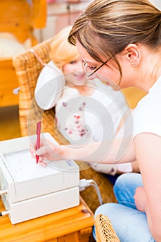 Midwife seeing mother for pregnancy examination