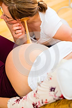 Midwife seeing mother for pregnancy examination