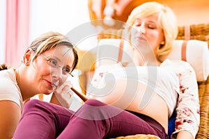 Midwife seeing mother for pregnancy examination photo