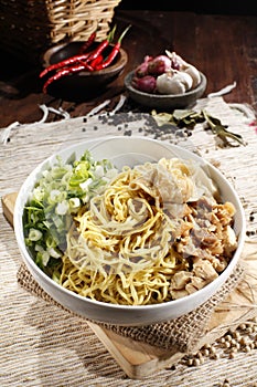 Mie ayam pangsit. Chicken dumpling noodles. Boiled noodles plus chicken, dumplings, mustard greens, sliced scallions