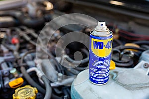 WD-40 multi purpose penetrating oil on old japanese car engine, space for text.