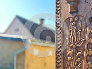 Detailed hand carved tulip on traditional hungarian oak wood gate pylon .