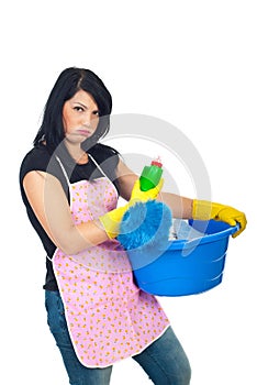 Miffed woman holding cleaning products photo