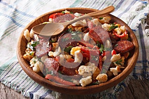 Migas with chorizo, bread crumbs and vegetables close-up, horizo