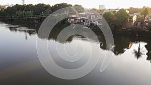 Mighty Paraiba do Sul river in Volta Redonda, Rio de Janeiro, Brazil. houses on the banks of the polluted river