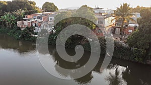 Mighty Paraiba do Sul river in Volta Redonda, Rio de Janeiro, Brazil. houses on the banks of the polluted river