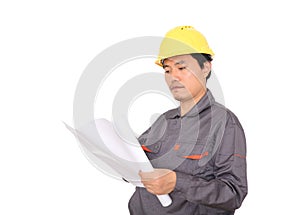 Migrant worker wearing yellow hard hat holding drawings in hand in front of white background