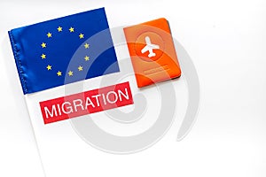 Migration to Europa concept. European flag near passport on white background top-down copy space