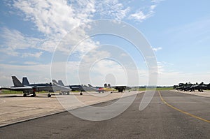 Miitary aircraft parked on the runway at an airshow