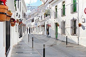 Mijas white washed street, small famous village in Spain. Charming empty narrow streets with New Year decorations