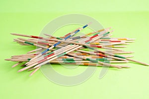 Mikado game on green background with wooden sticks