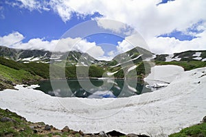 Mikurigaike pond and Tateyama mountain range with snow in summer