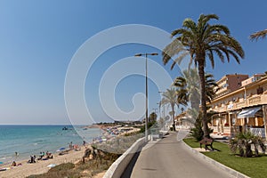 Mil Palmeras Costa Blanca Spain with people on the beach and palm trees photo