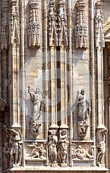 Milan Cathedral Duomo di Milano close-up, Milan, Italy. Detail of luxury facade with marble statues and reliefs. Milan Cathedral