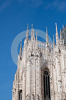 Milan Cathedral Facade: Arched Windows Against Blue Sky