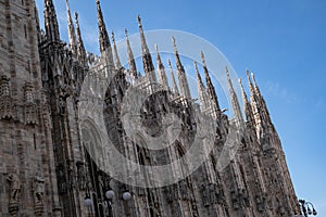 Milan Cathedral Facade with Spire Rows Against Blue Sky