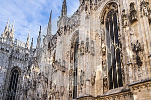 The Milan cathedral\'s exterior is adorned with a multitude of intricate sculptures, spires, and architectural details