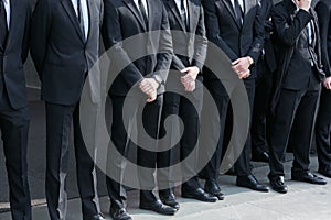 Bodyguards in black suit before Giorgio Armani fashion show, Milan Fashion Week street style on February 27,